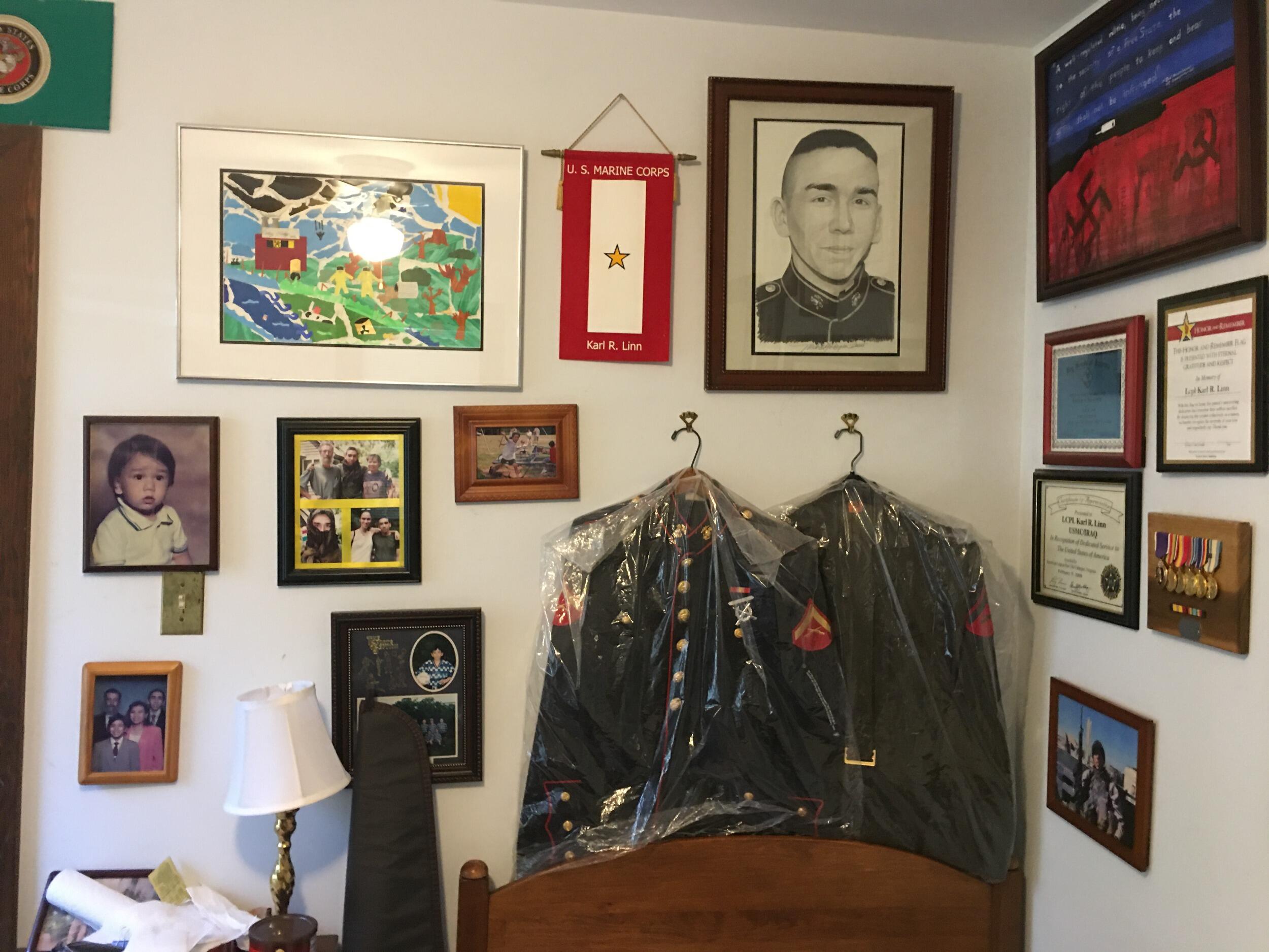 Karl Linn's formal dress blues hang at the head of his bed with other awards and mementos.