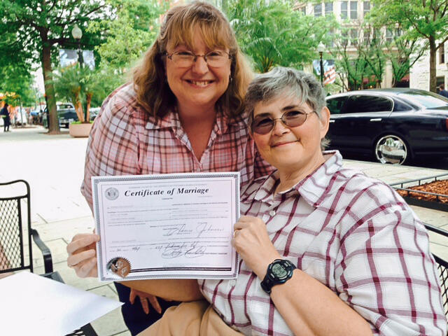 Lisa and Tina Webb with their marriage certificate.