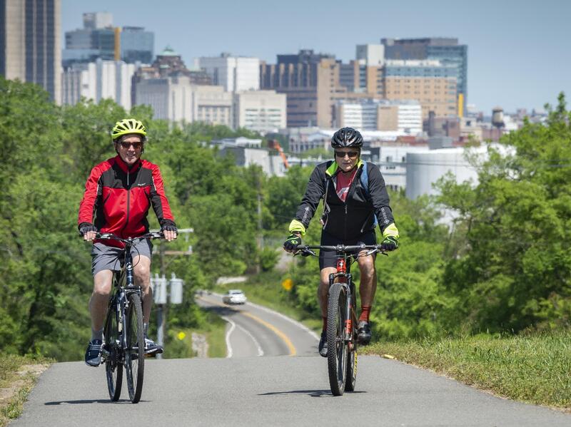 Nelson Gustin of Winchester, Va. (left) and Randy Parker of Louisa, Va. ride the Virginia Capital Trail just east of downtown Richmond. Photo by Kevin Morley, University Marketing.