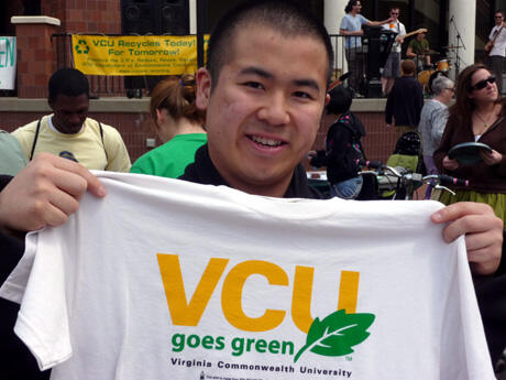 A perfect fit!  Sophomore Timmy Nguyen, who is studying business administration, shows off a shirt that expresses VCU’s commitment to being a “green” university.  