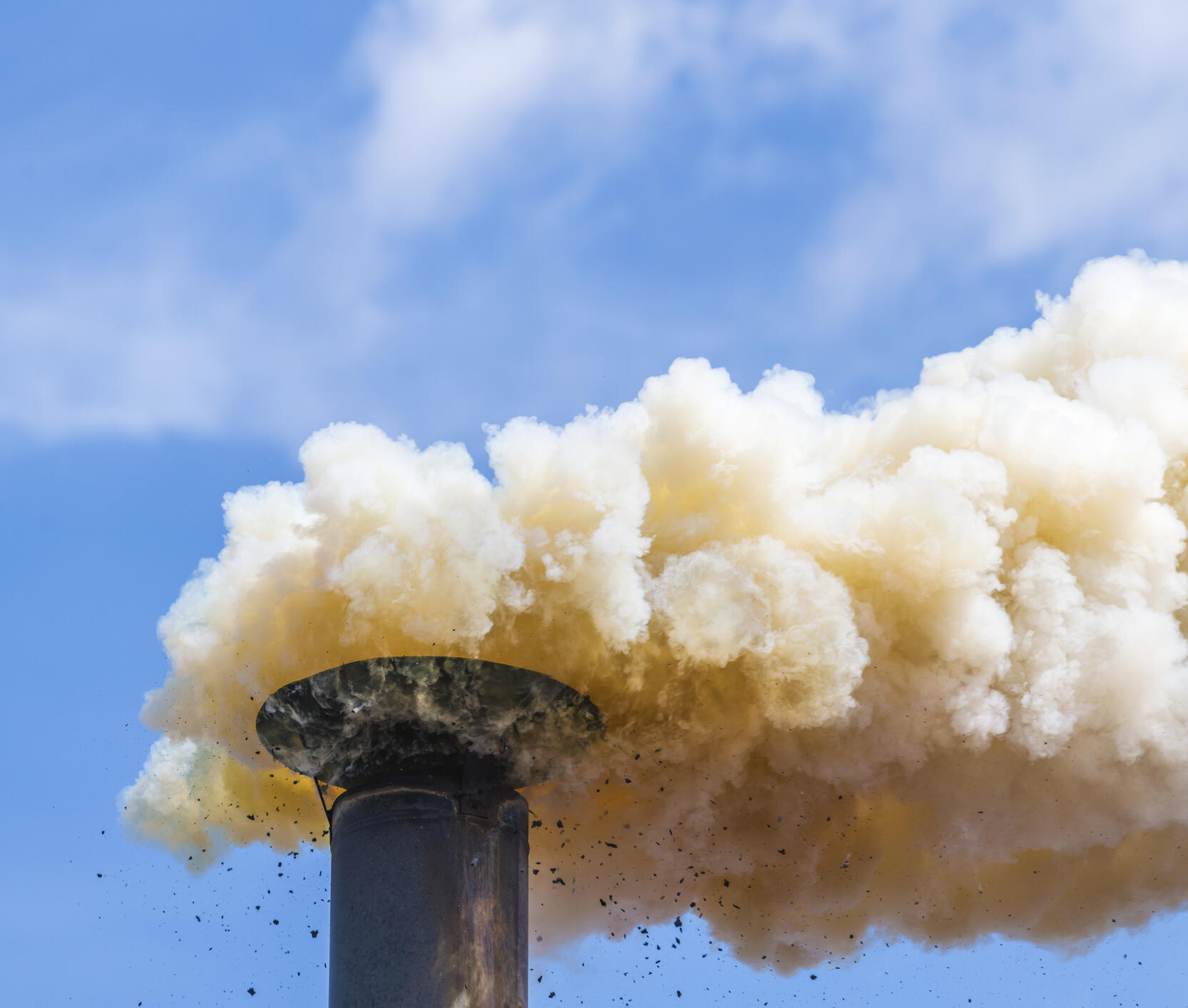 Smoke billowing from a smoke stack.