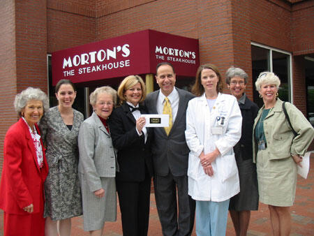In front of Morton's newest restaurant, near Richmond's Canal Walk, from left, Judith Jones, immediate past president, MCVH Auxiliary, Denielle Vendetti, sales & marketing manager for Morton's, Charlotte Roberts, 1st vice president for projects, MCVH Auxiliary, Bennington, Ornato, Martin, Julia Poppell, treasurer, MCVH Auxiliary, and JoAnn Burton, president, MCVH Auxiliary celebrate their successful partnership and are already discussing plans for "A Night to Remember" sequel event next winter.

Photo by Michael Ford, University News Services