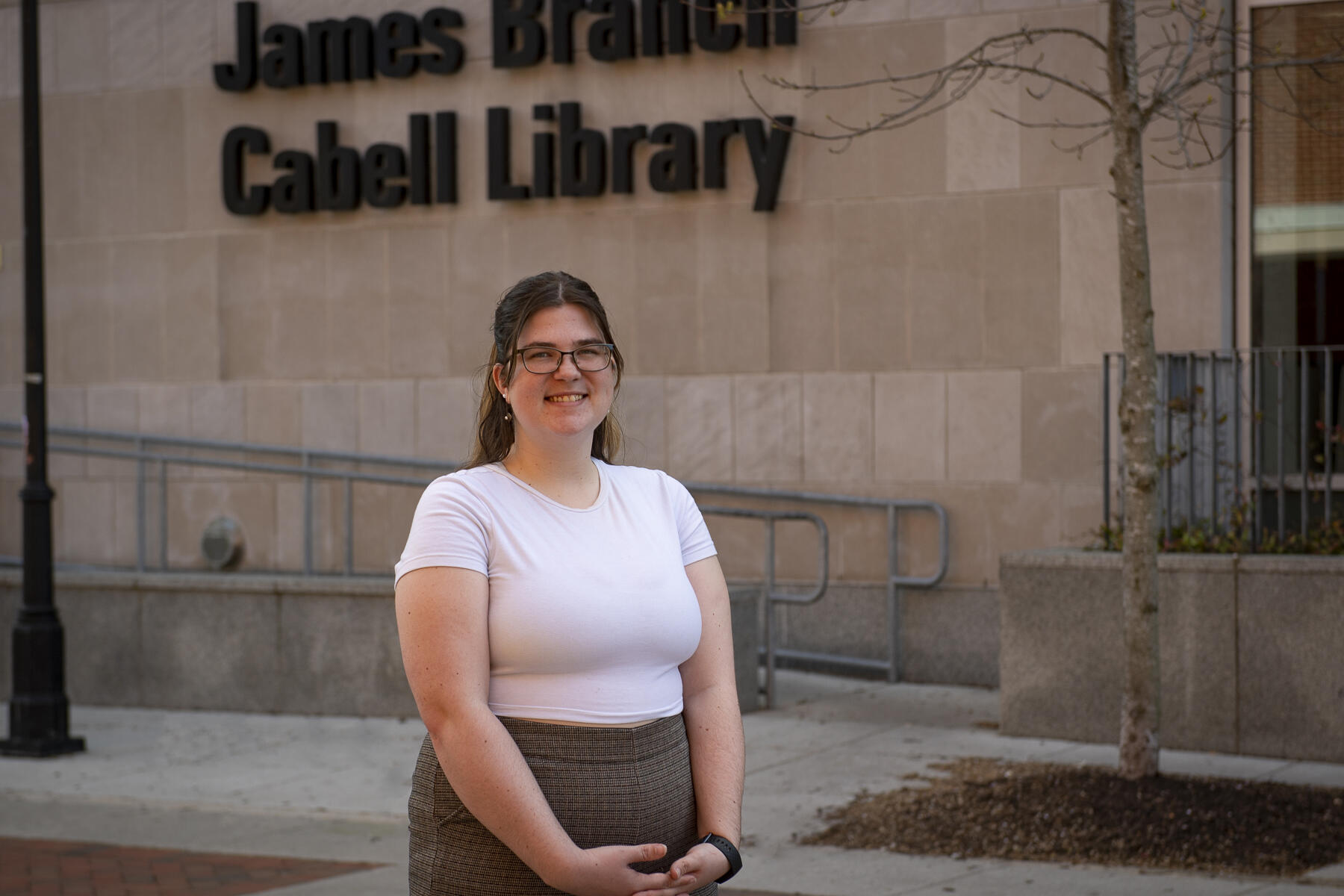 A portrait of a woman standing in front of the James Branch Cabell Library