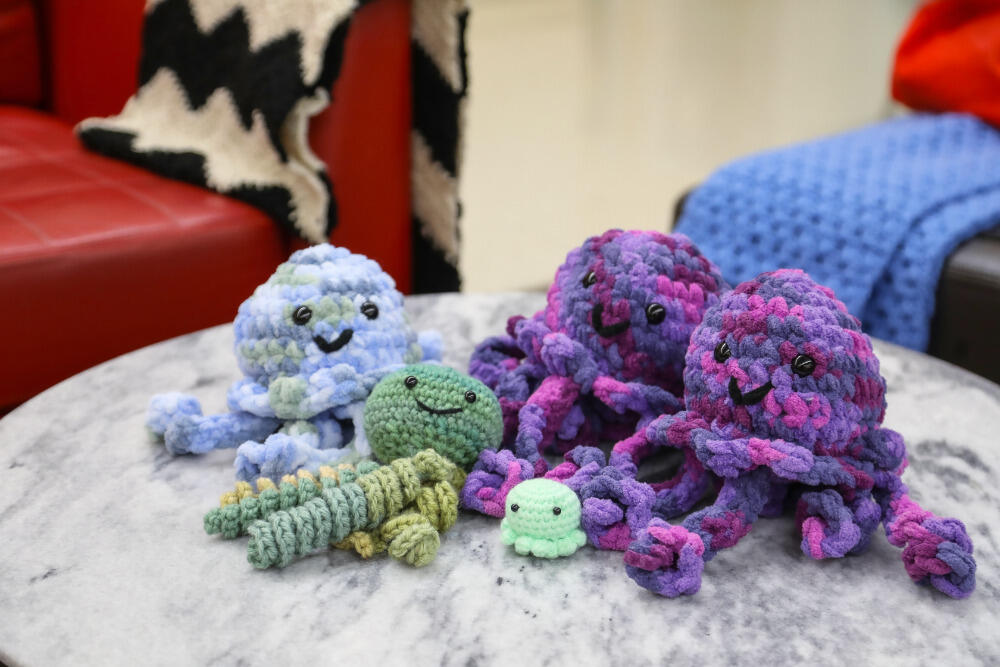 A photo of five knitted jelly fish toys. 