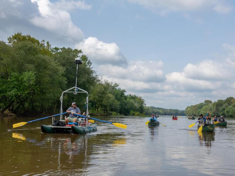 VCU students paddle alongside a Terrain360 boat that generated a panoramic virtual tour of an 11-mile stretch of the Middle James River studied by the students