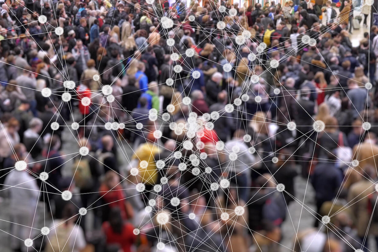 A blurry photo of a crowd of people with lines connecting dots overlaid.