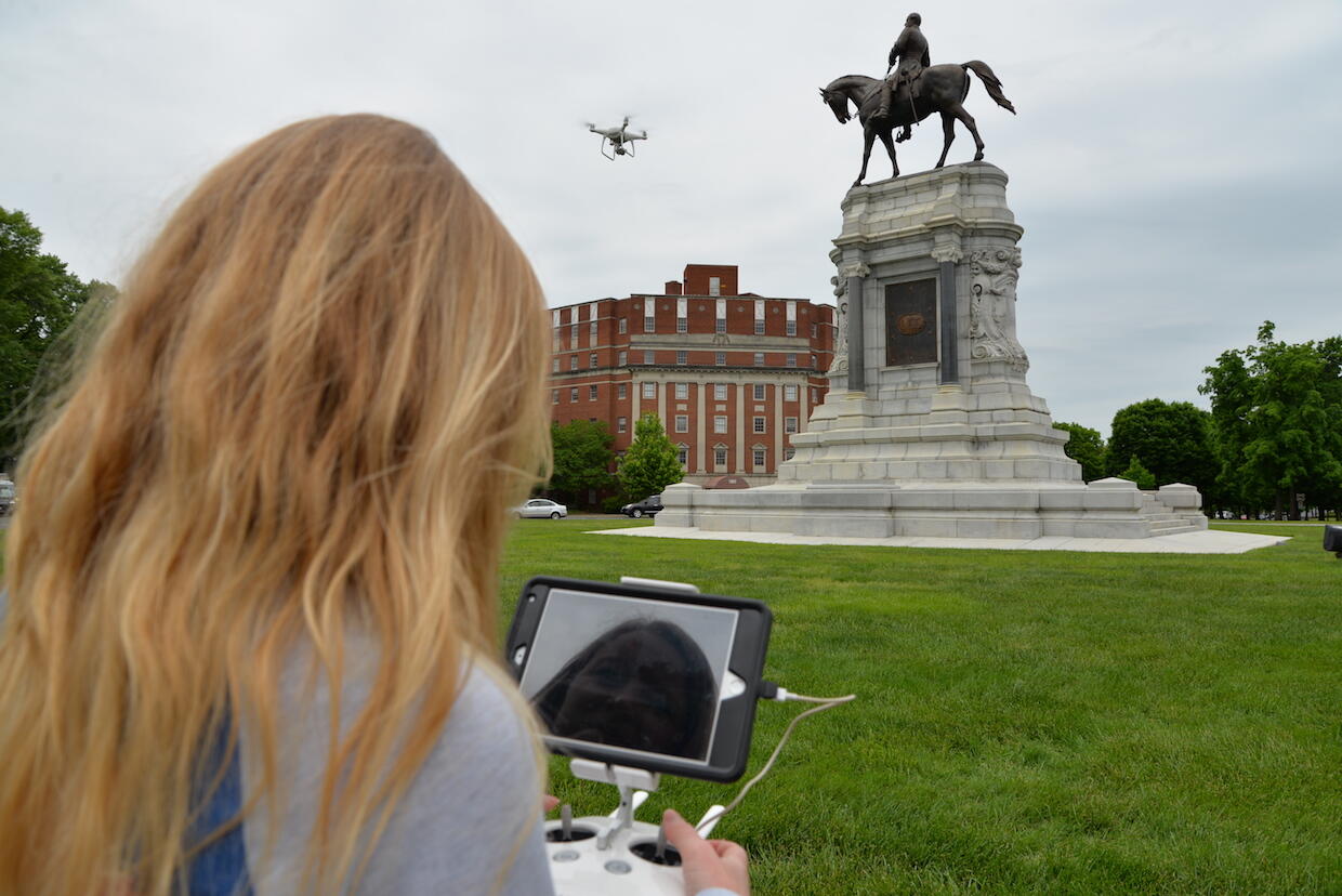 VCU alumna Ashley McCuistion pilots a drone to take photographs of the Robert E. Lee monument on Richmond's Monument Avenue.