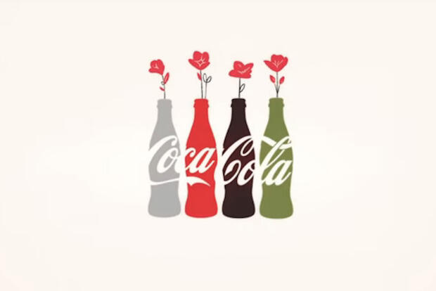 Four bottles spelling Coca Cola