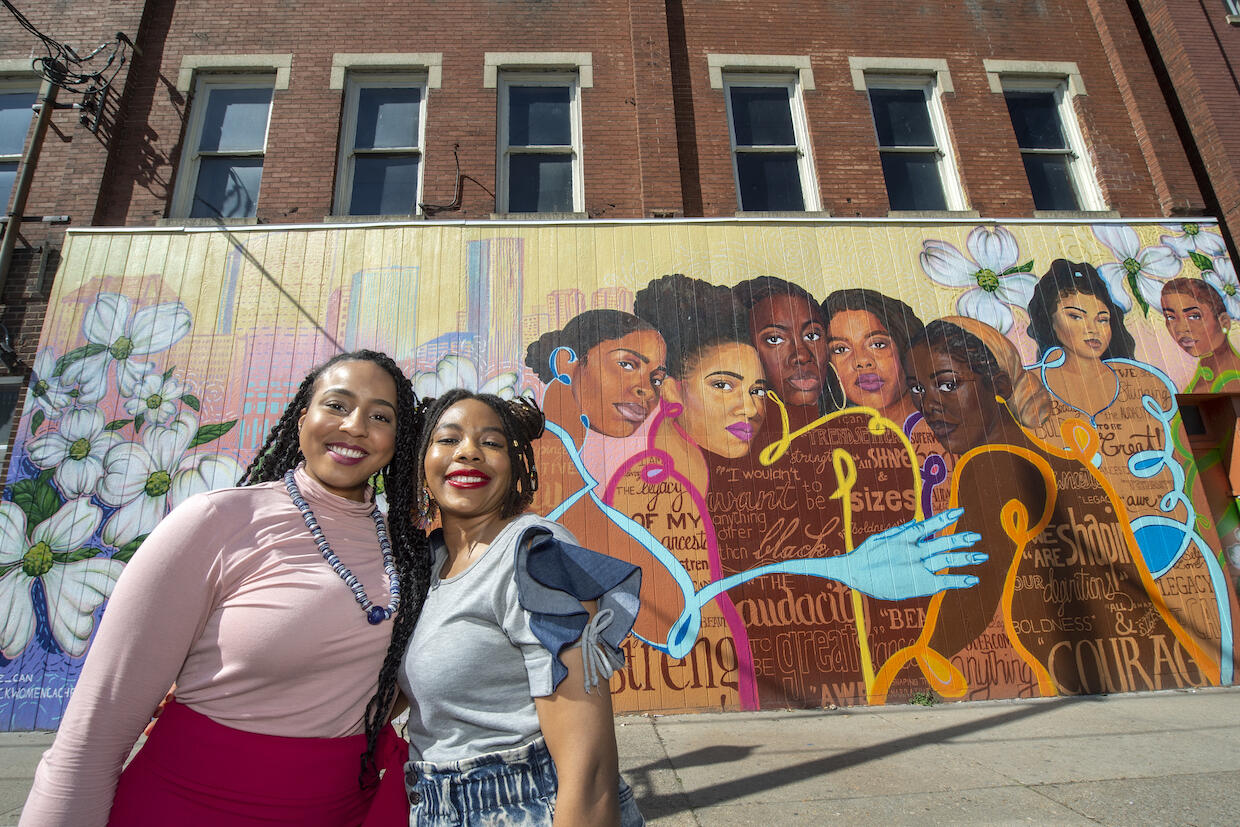 Austin Miles, left, and Kristal Brown pose together in early March in front of a mural the two created.