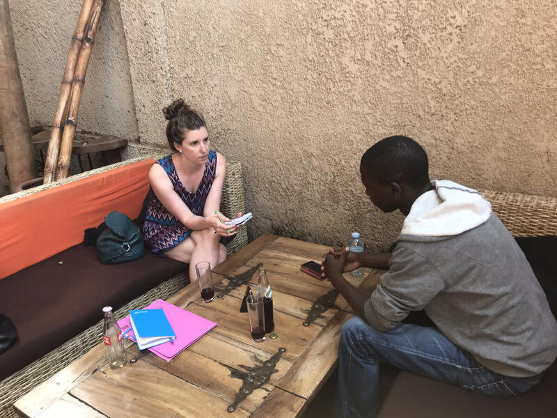 Karen McIntyre Hopkinson, Ph.D., associate professor in the Richard T. Robertson School of Media and Culture, interviews a journalist in East Africa. (Photo credit: Meghan Sobel Cohen)