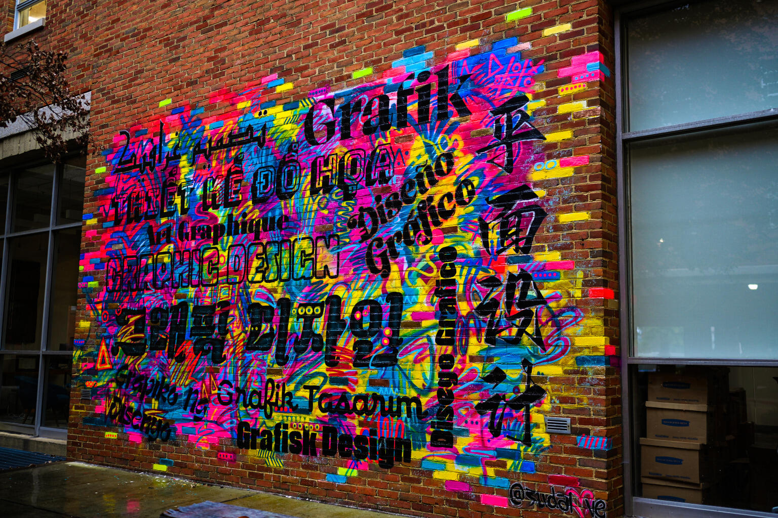 A multicolored mural painted on a brick wall. 