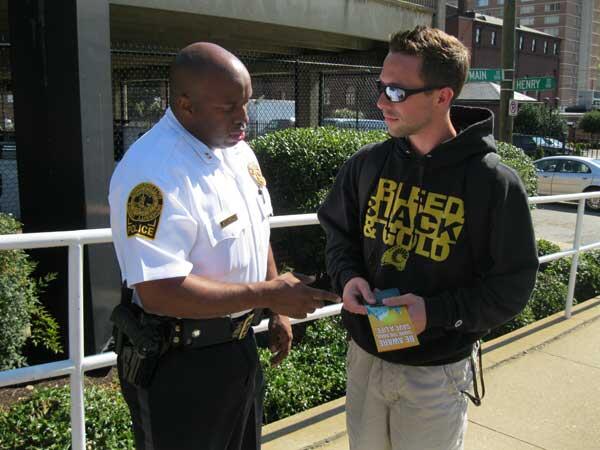Captain Sean Ingram shares pedestrians' rights and responsibilities with VCU junior Justin Walters. Walkers should always use caution and make sure bicyclists and motorists can see them. 