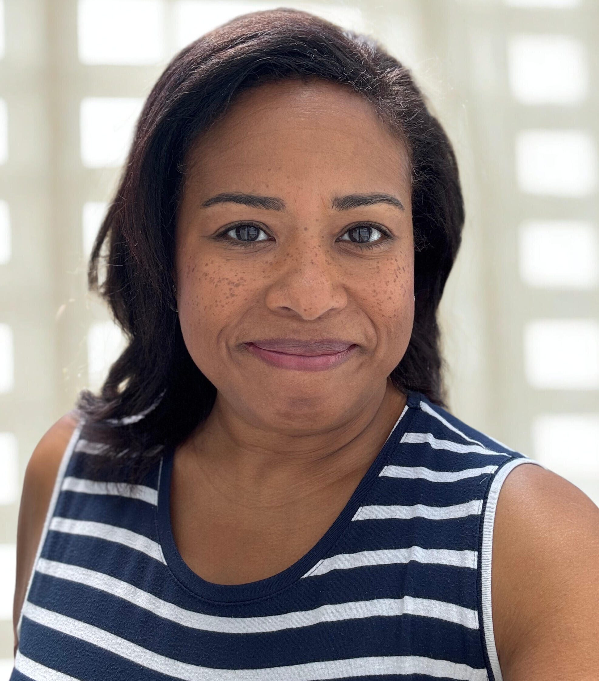 A photo of a woman from the shoulders up. 