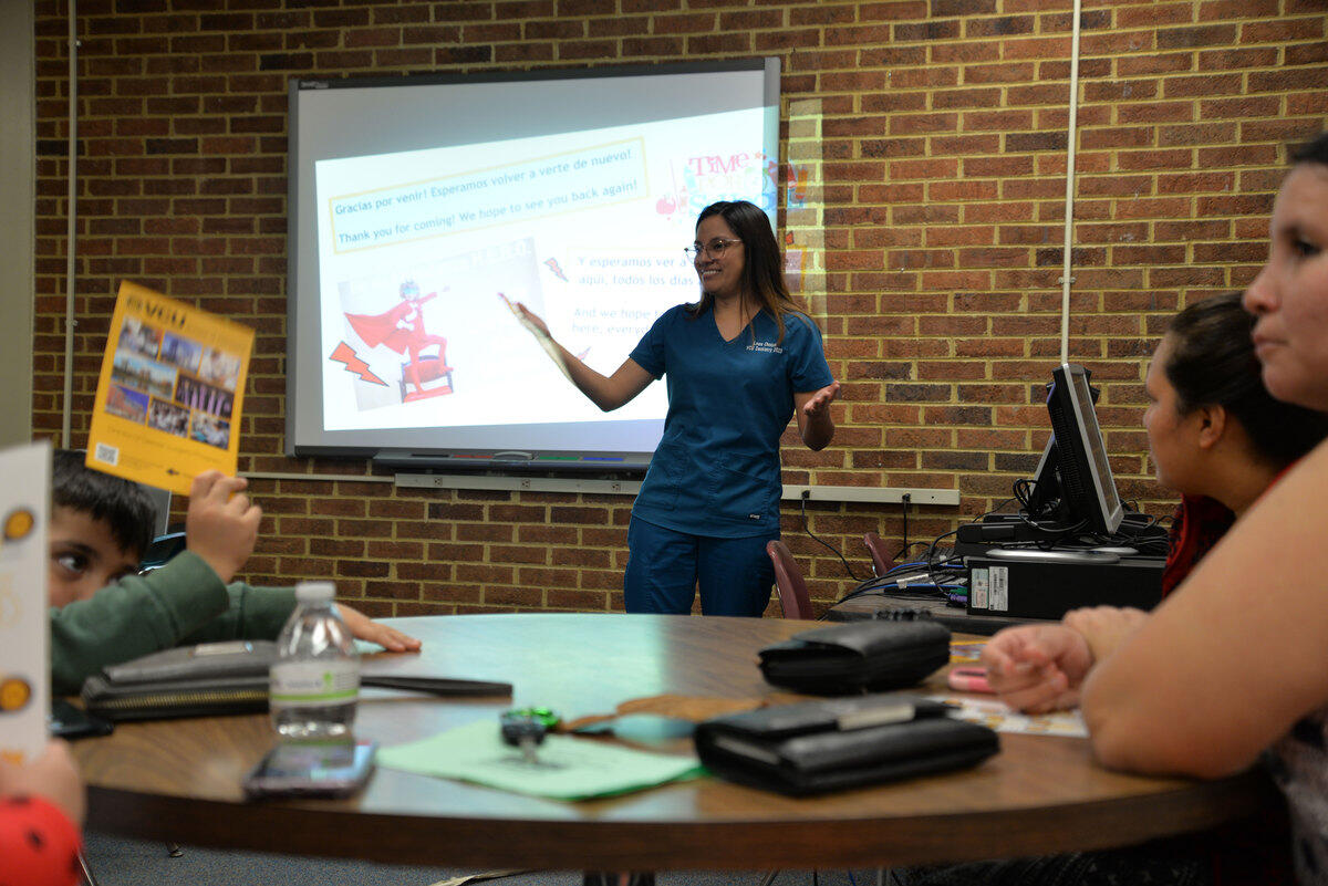 Laura Choque, a student in the VCU School of Dentistry, speaking to a group of people in a classroom.