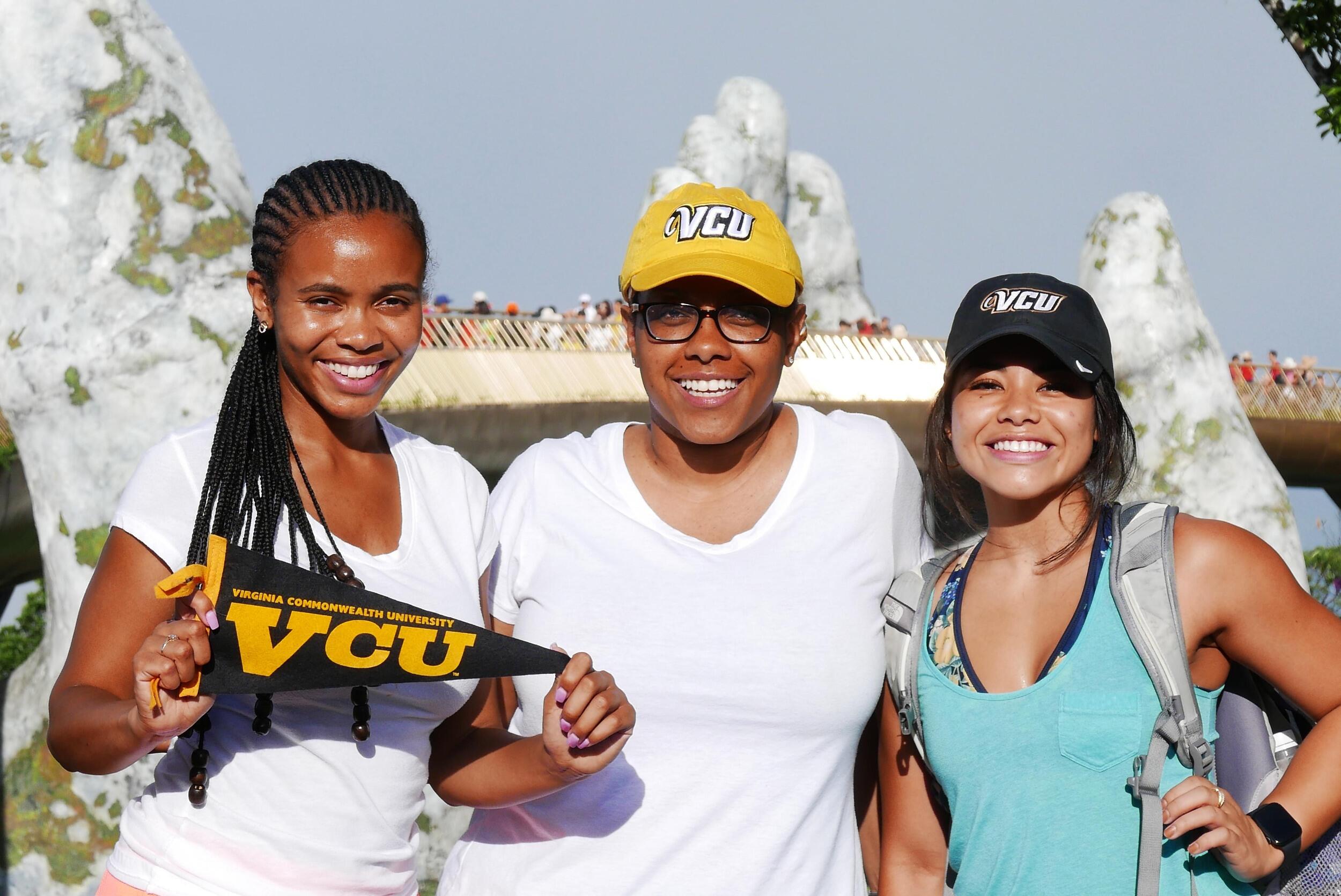 Three VCU students posing in front of the Golden Bridge at Ba Na Hills.
