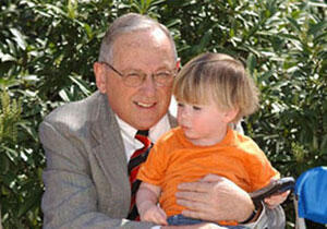 Dr. Eugene P. Trani, VCU president and grandson Renn Trani share a moment together during the auction. - M. Janis
