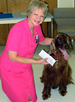 Sandy Barker, Ph.D., director of VCU’s Center for Human Animal Interaction, poses proudly with Reilly, an Irish Setter who along with his owner, Michael Kallighan (not pictured), has been visiting patients at the VCU Medical Center as part of the VCUMC Dogs on Call program. 

Photo by Malorie Janis, University News Services