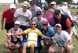 Sweet Victory! Thomas Waldrop, D.D.S., (in the black cap and vest), and members of the Richmond Triathlon Club after completing the Ironman Eagleman 70.3 race. Seated in the chair donning a yellow shirt is Natasha Badmann, the number one ranked female pro in the world. She is from Switzerland and has won the Ironman World Championships multiple times and is the female to out play this year in Hawaii. Personal image courtesy of Thomas Waldrop/VCU.