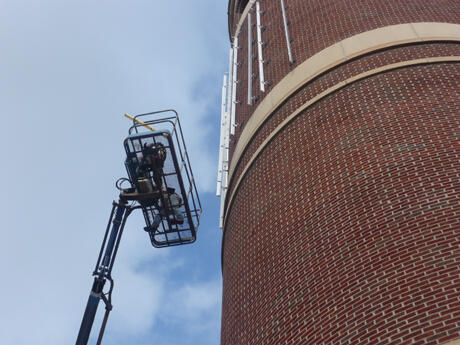 Crews from Cityspace Solar worked high in the sky to install the new solar panel array on the south side of the plant’s stack.