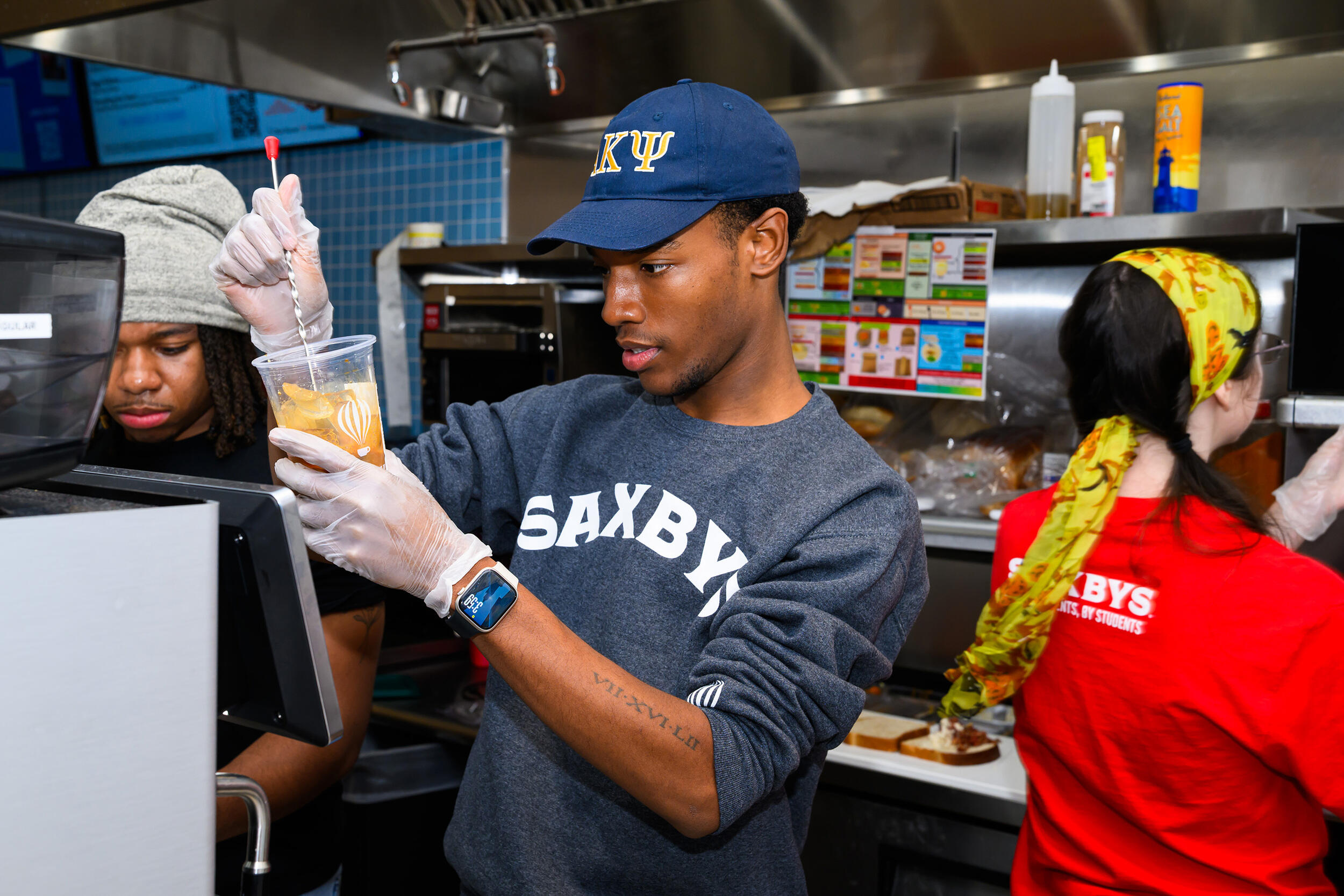 A photo of students working in a professional kitchen. 