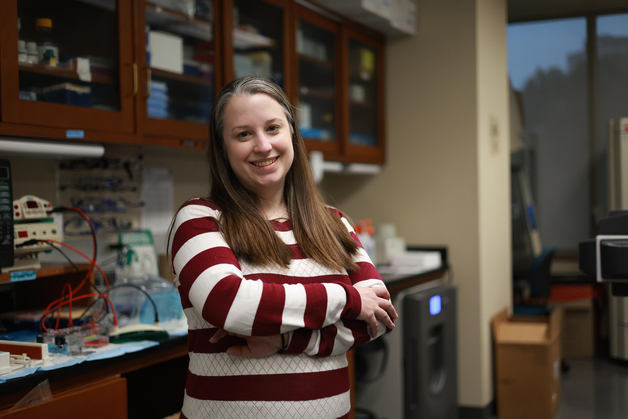 A photo of a woman standing in a lab. 