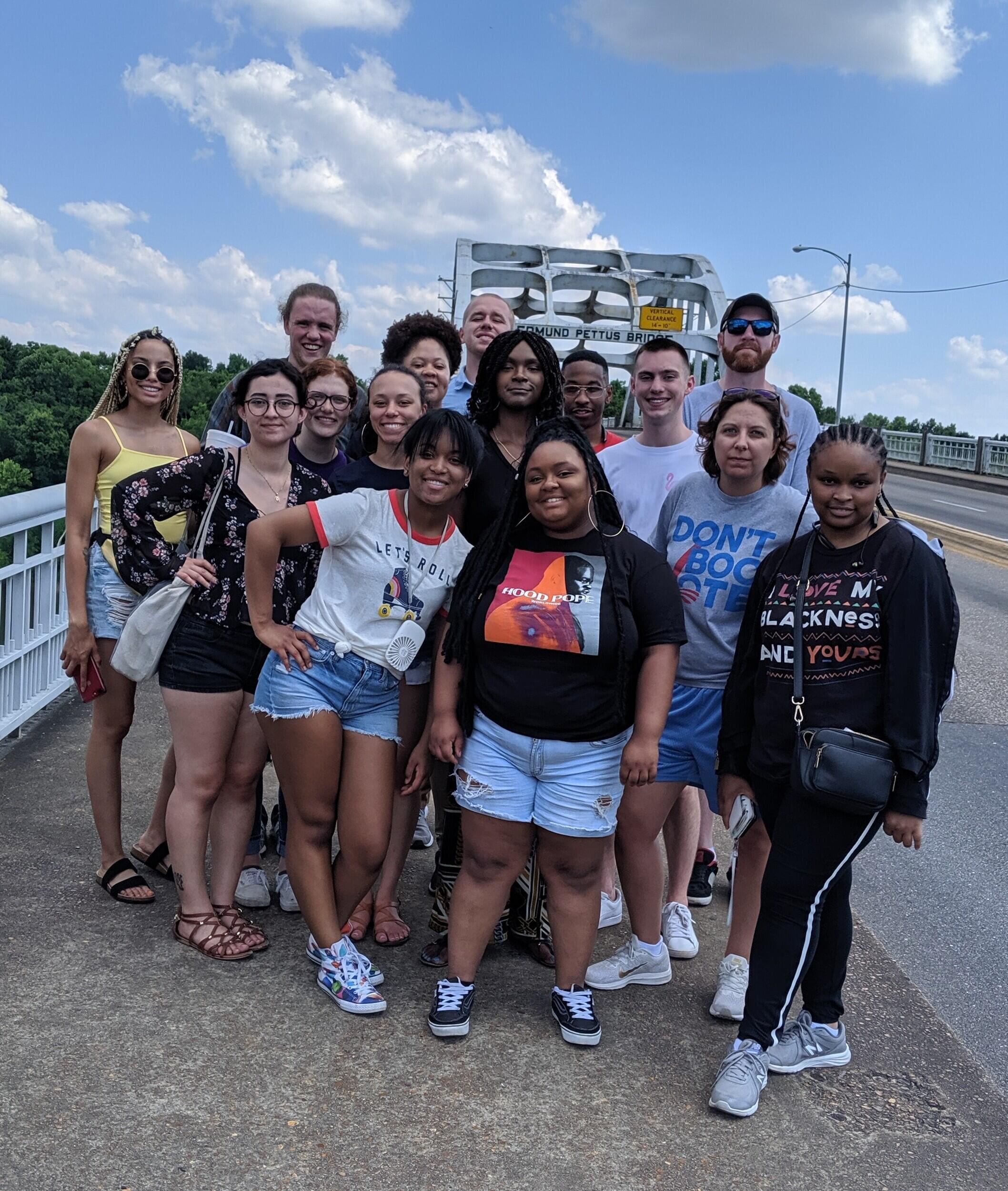 Fifteen people from VCU posing for a photo on the Edmund Pettus Bridge in Selma, Alabama.