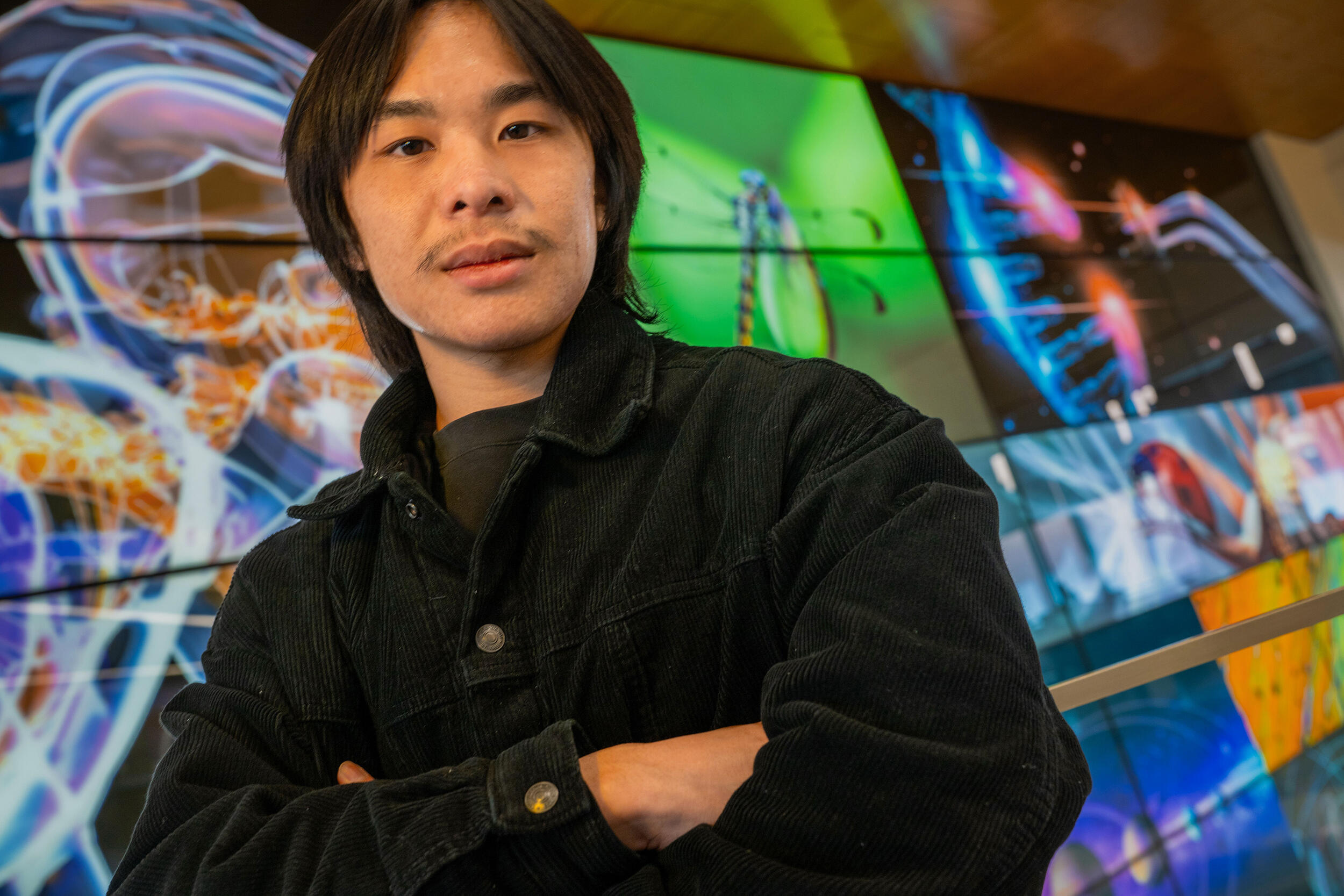 A photo of a man with his arms crossed against his chest.