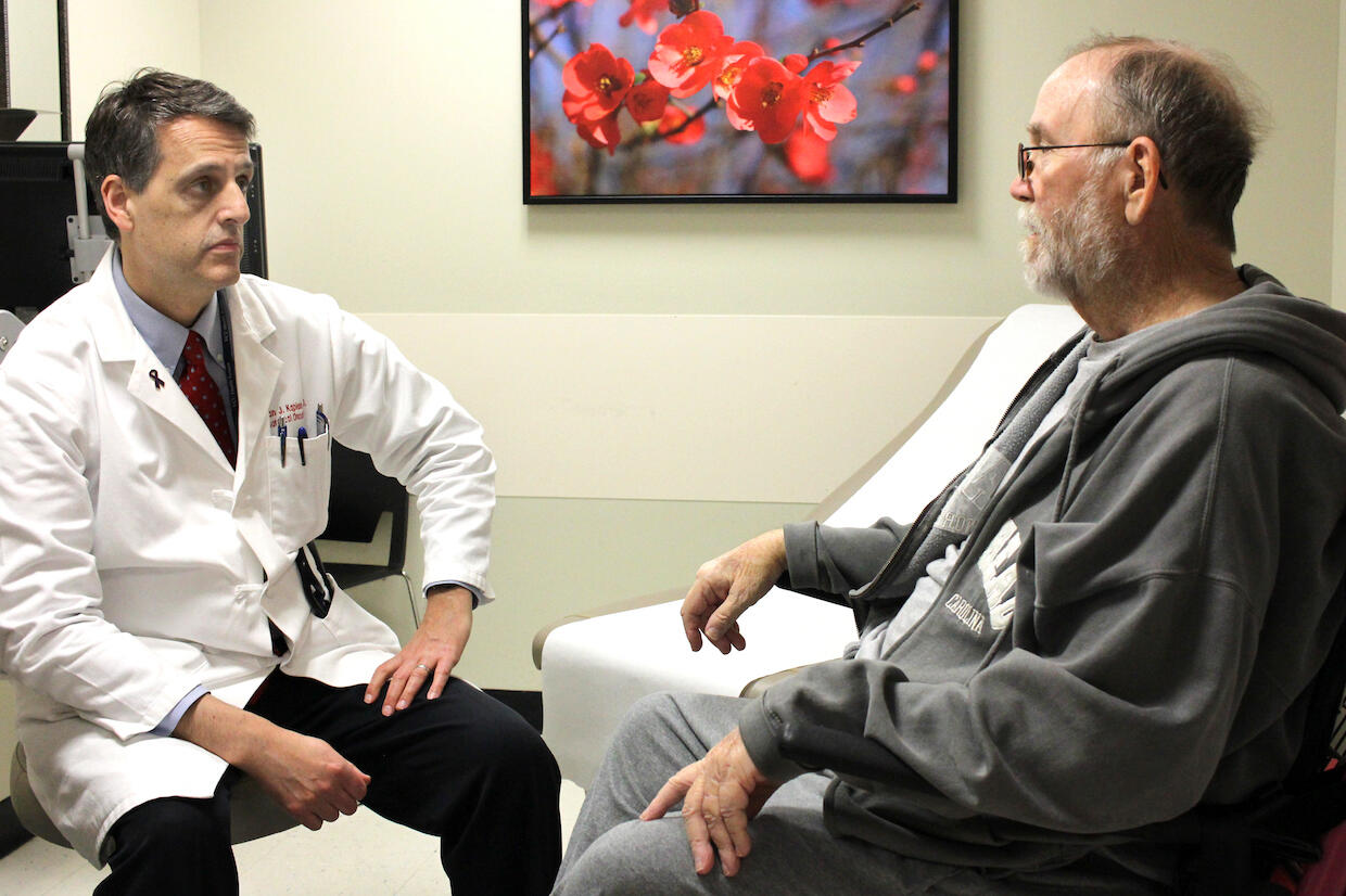 Surgical Oncologist Brian Kaplan, M.D., meets with William Grubbs, Jr., following his surgery. 