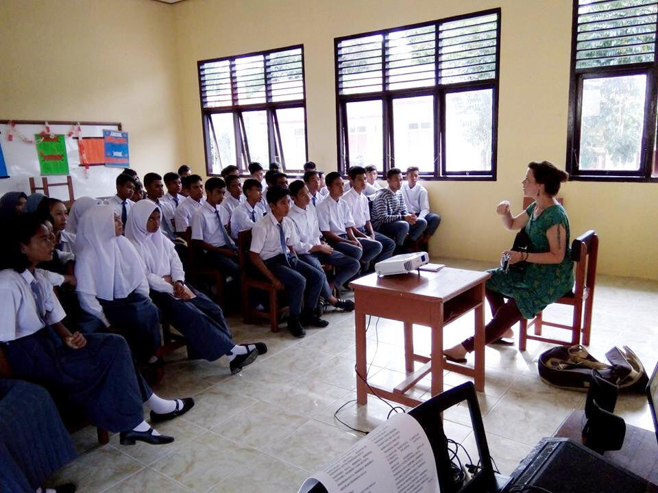 Hannah Standiford speaks to a classroom of students while in Indonesia.