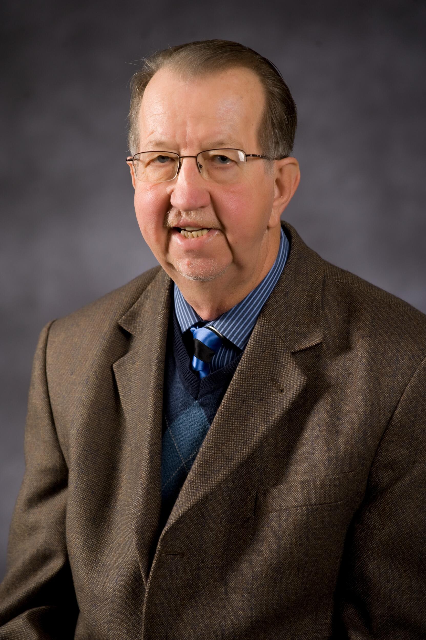 A photo of a man from the shoulders up. 