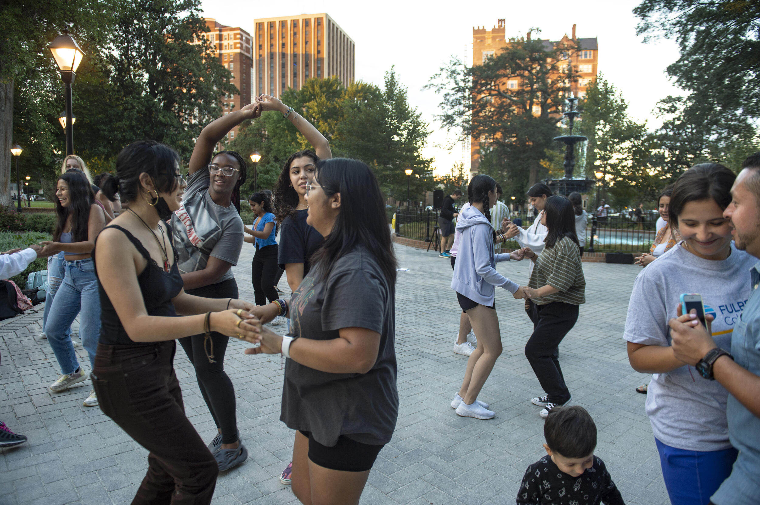 People dancing in front of a fountain in Monroe Park 