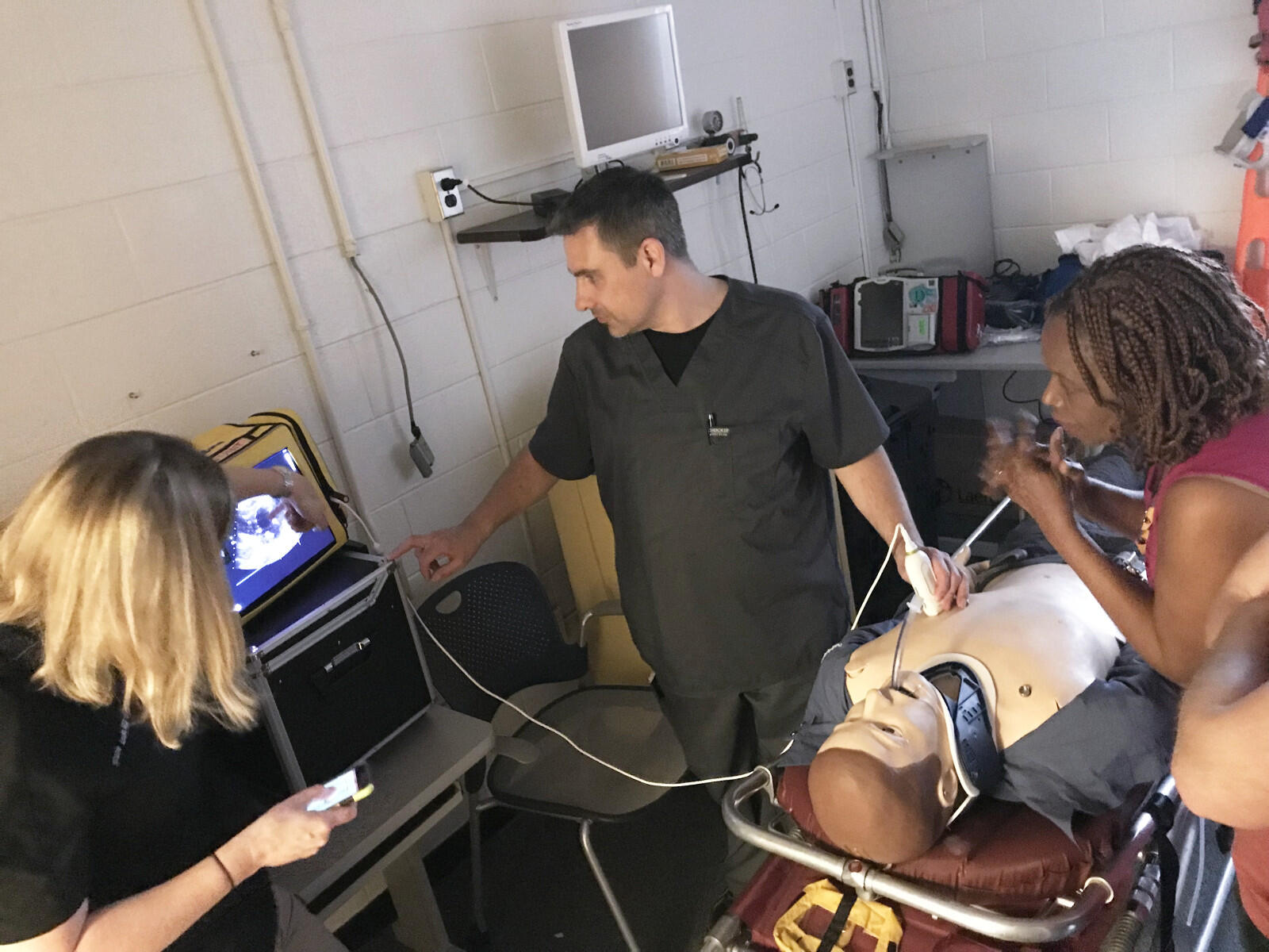 Shawn Lawrence, a paramedic, uses ultrasound on a dummy as part of a simulated exercise to diagnose the condition of a 62-year-old male who collapsed at a gym.

