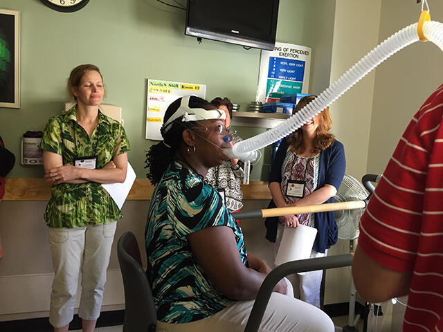 Tia Moore, an Alexandria Virginia teacher and a 2015 CRESST Summer Academy participant, learns what it's like to be a research subject as measurements of her metabolic rate are taken at the VCU Clinical Research Services Unit. 