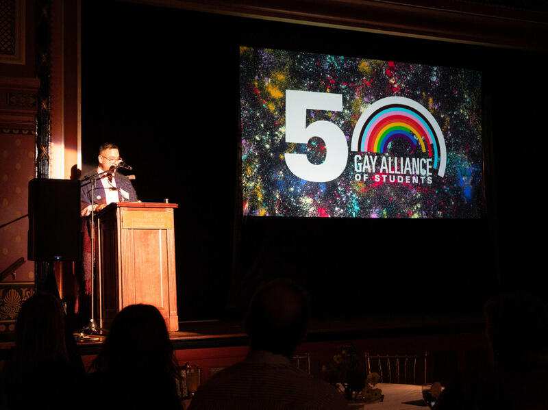 A photo of a man standing behind a podium. 