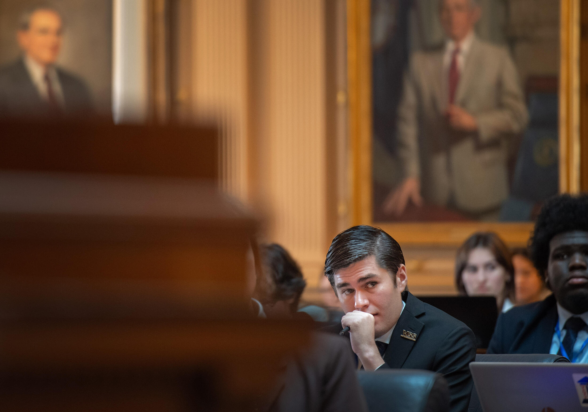 A photo of a man sitting. 