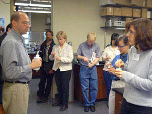VCU Department of Chemical Engineering Chair Gary E. Wnek, Ph.D., (left) demonstrates how viscosity is related to the shape of polymer coils in solution to medical product developers enrolled in the School of Engineering's First Annual Polymers in Medicine course.

Photo by Mike Frontiero, University News Services