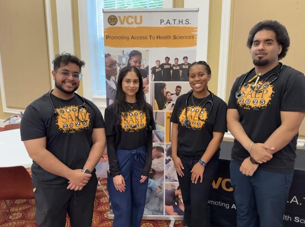 A group photo of four people. 