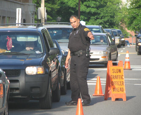 Corporal Marvin Wingo, canine supervisor, prepares to check a vehicle for seat belt compliance and other safety issues. Of the 465 vehicles passing through the checkpoint, officers arrested two people for driving under the influence and issued 121 traffic citations, including 20 for seatbelt violations, 29 for expired registrations, 26 for outdated vehicle inspections and 12 for operating a vehicle without a license. Photo provided by Officer Michael Roser, VCU Police Department. 