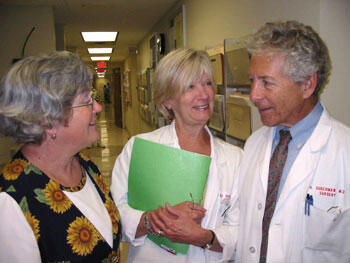 Dr. Harvey Sugerman, right, confers with longtime administrative assistant Diane Wingo (left) and Betsy Sugerman, R.N., (wife and clinic nurse) about the patients expected on his final afternoon at the Ambulatory Care Center.