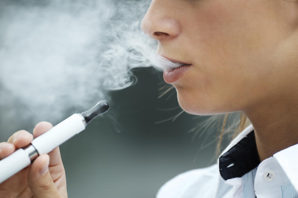 A close-up of a person vaping.