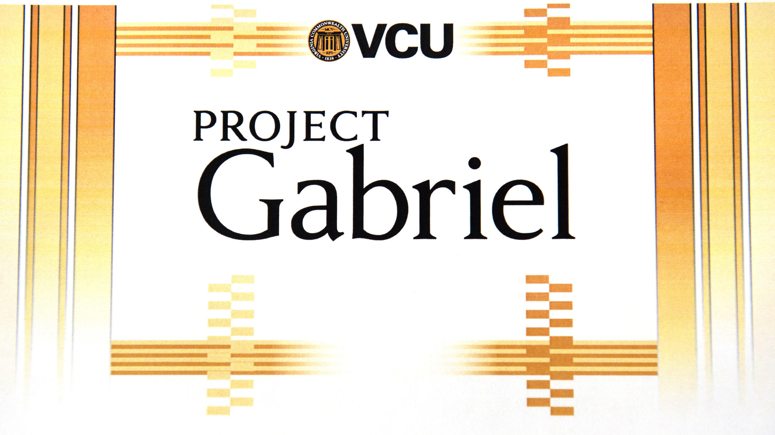 Yellow and gold lines in a boarder around black text that reads \"VCU PROJECT Gabriel.\" 