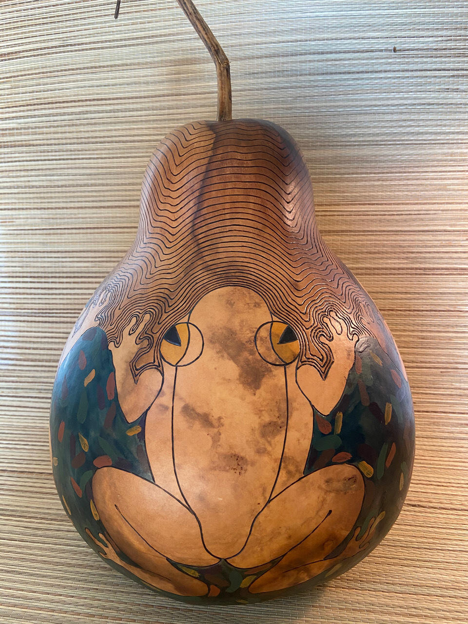 A dried gourd with an illustration of a frog on it 