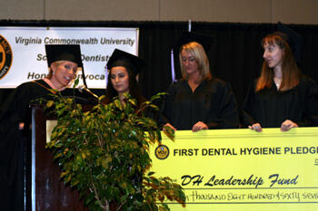 Senior Dental Hygiene students present check for $16,867 to director of Dental Hygiene, Kim Isringhausen. From left: Isringhausen, Golby Jalali, Lori Muss and Erin Knouse.