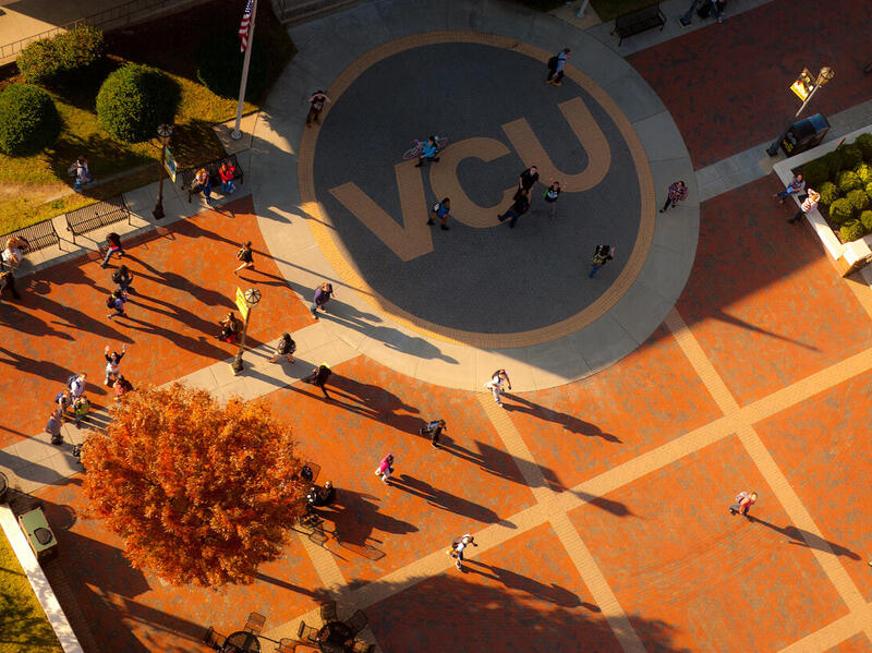 An areal photo of the VCU Student Commons plaza with people walking across it. 