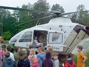Step Right Up. Too large to fit inside a classroom, VCU LifeEvac helicopter turns the lawn at South Anna Elementary School into a traveling show and tell lab during career day activities.

Photos courtesy of Melissa Hunt, VCUHS