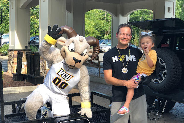 Louie Correa, center, with his daughter, Maddie, and Rodney the Ram at the July 19 Birthday Brigade.