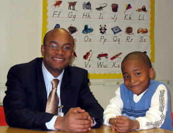 Carver Elementary first-grader Jarell Jones and his mentor, Reggie Skinner, read together, play games and sometimes just talk. The Virginia Mentoring Partnership, part of VCU’s Division of Community Engagement, is working to find a mentor for every child in Virginia in need of one. Photo by Mike Porter/VCU Office of University News Services