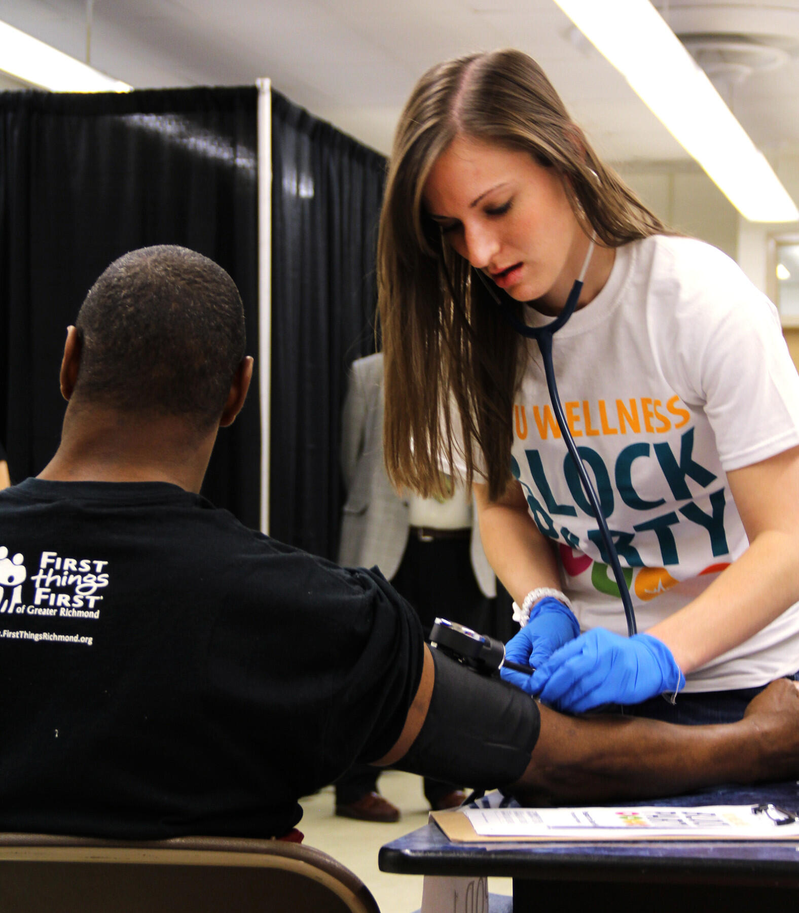 A volunteer health sciences student checks the blood pressure of a participant during the MCV Campus Student Government Association's eighth annual VCU Wellness Block Party in 2015.