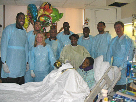 Full Court Press. VCU Rams team members encircle 13-year old Maurice Ealy's hospital bed during an afternoon visit to talk about hoops and a healthy attitude. From left to right, center Kevin Moore, guard Julian Capel, Michelle Meadows, assistant compliance director, VCU intercollegiate athletics, Peyton Owens, life skills coordinator, VCU intercollegiate athletics, forward Nick George, Maurice's mother, Melissa Ealy, guard Dominic Jones, forward Michael Doles, Dr. John McCarty.

Photos by Michael Ford, University News Services