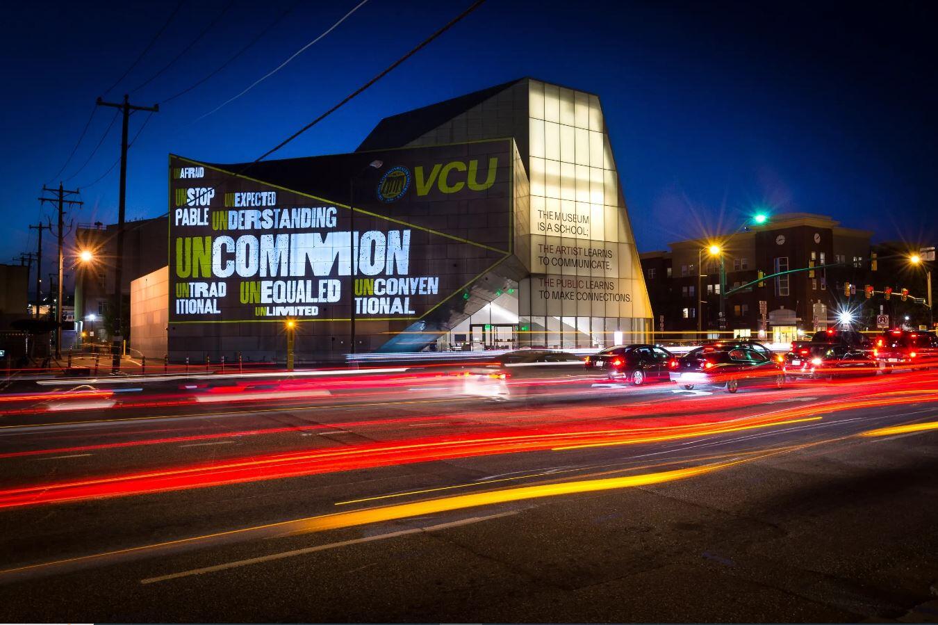 A photo of the ICA building lit up at night 